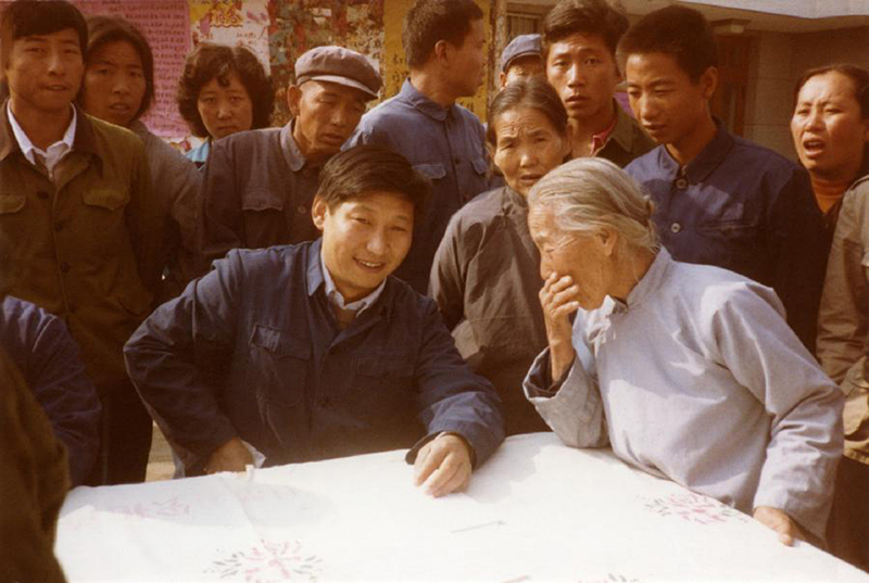 1983年，時(shí)任河北正定縣委書(shū)記的習(xí)近平（前排居中），臨時(shí)在大街上擺桌子聽(tīng)取老百姓意見(jiàn)。